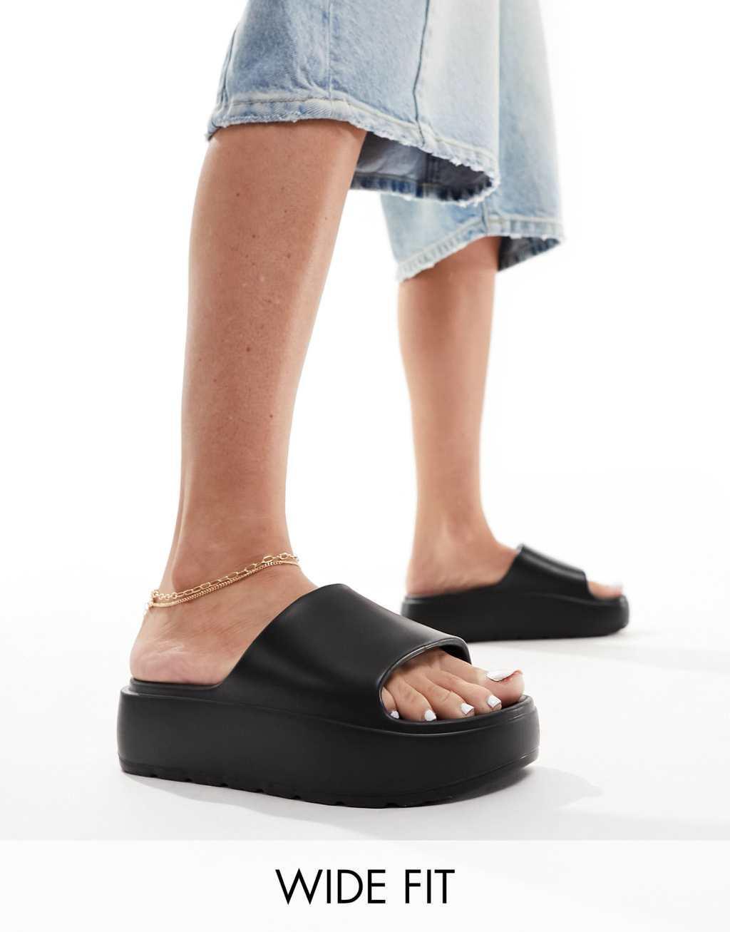 ASOS DESIGN Wide Fit Freedom cleated flatform slides in black Product Image