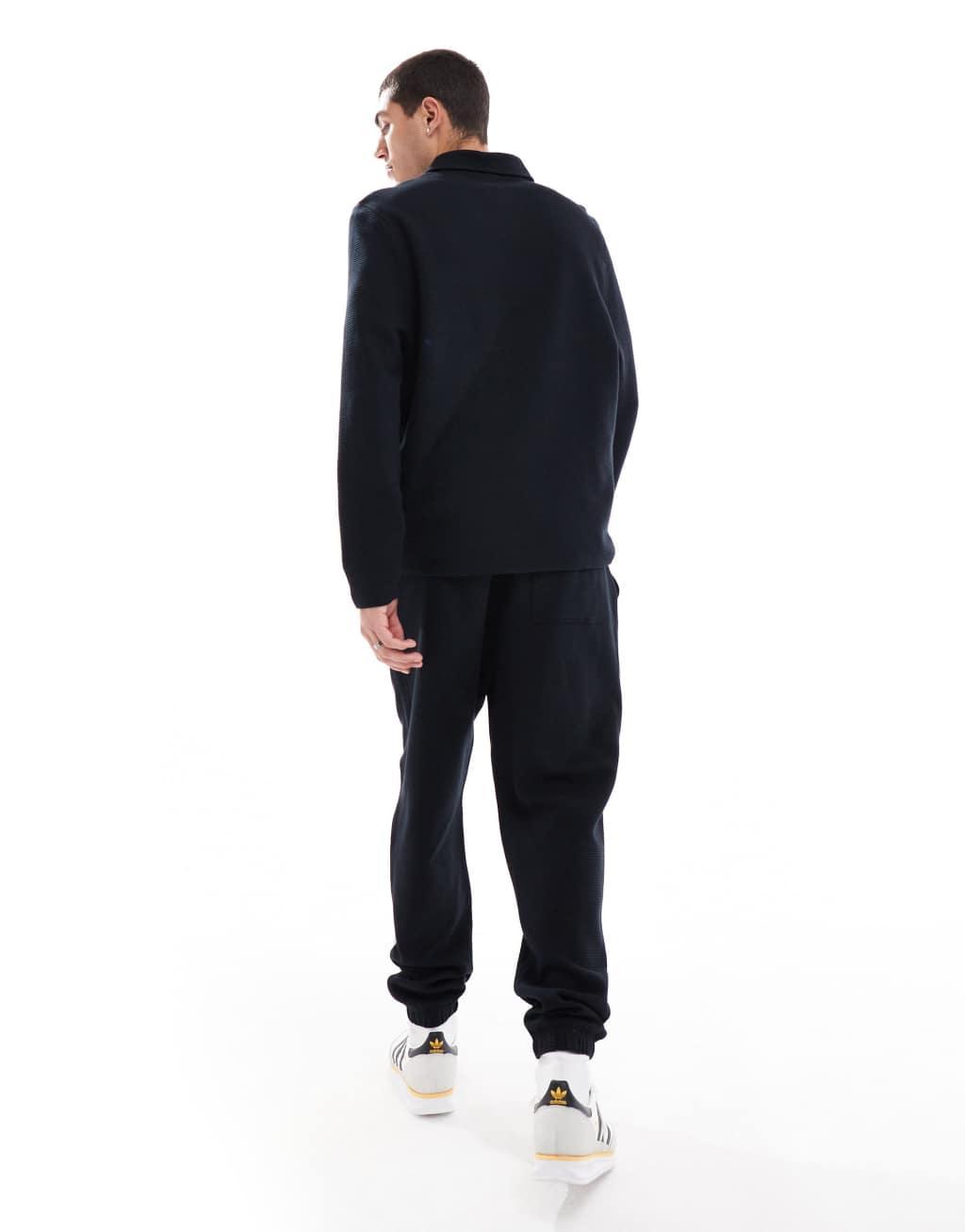 ASOS DESIGN tapered rib sweatpants in black Product Image