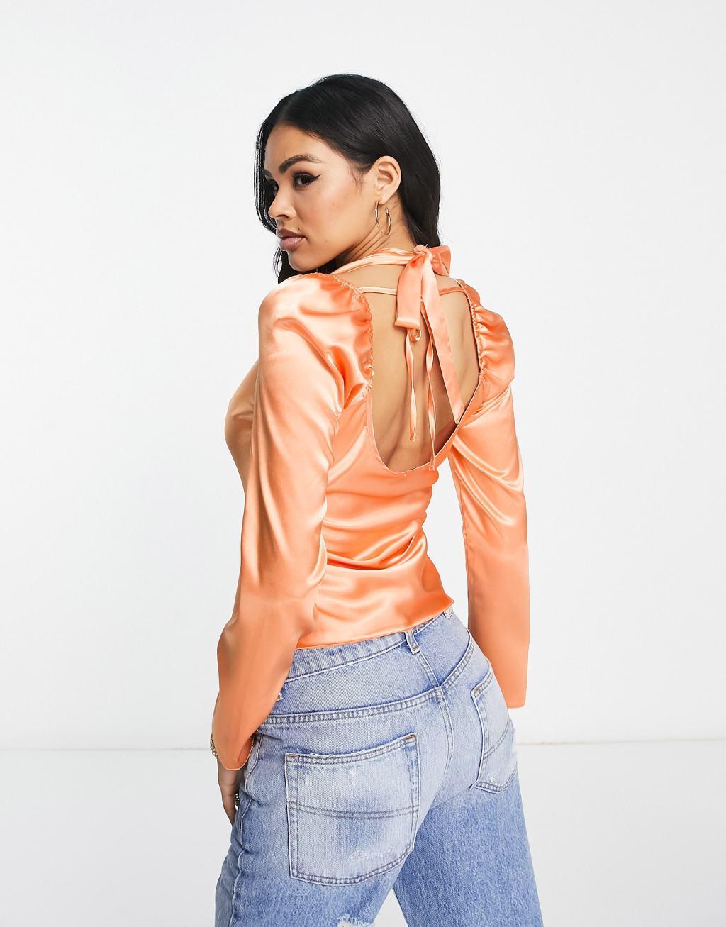 ASOS DESIGN twist front satin blouse with halter neck in peach Product Image