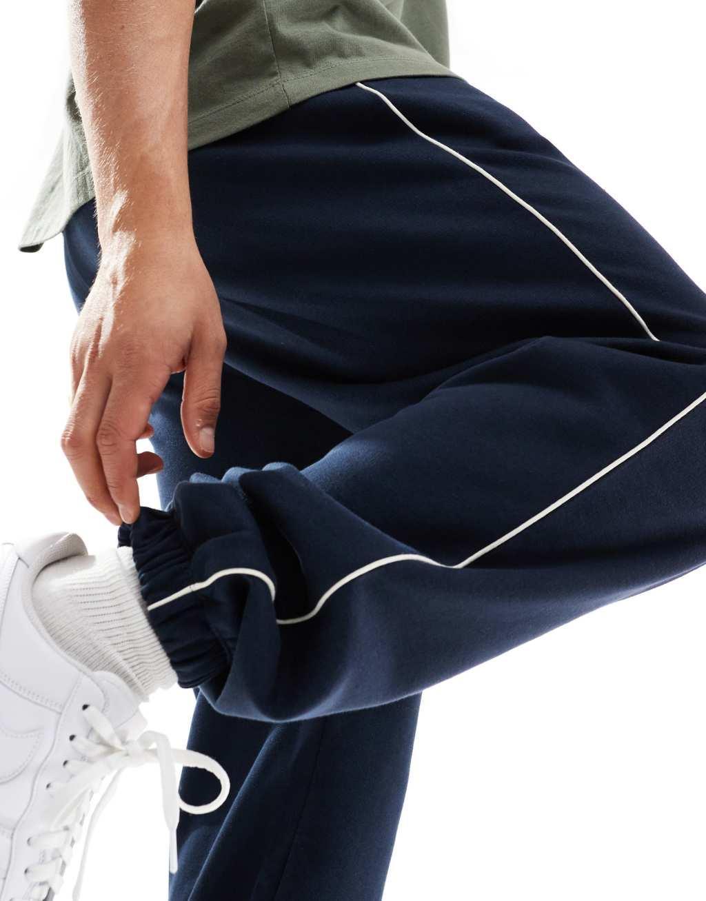 ASOS DESIGN oversized sweatpants with piping in navy Product Image