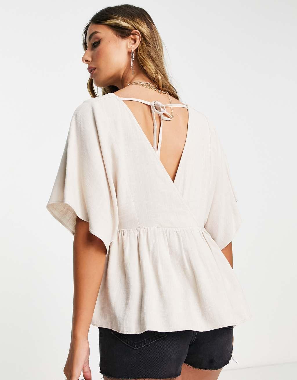 ASOS DESIGN wrap top with angel sleeve & peplum hem in natural Product Image