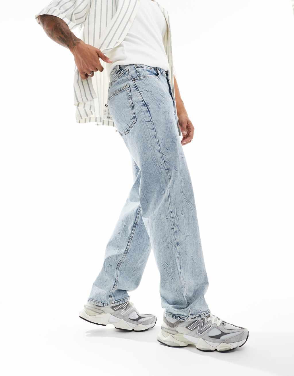 ASOS DESIGN baggy fit jeans in light wash blue with heavy acid wash Product Image