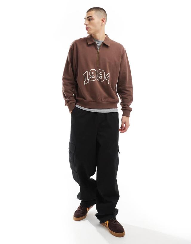 ASOS DESIGN boxy oversized polo sweatshirt with print and tipping detail in brown Product Image