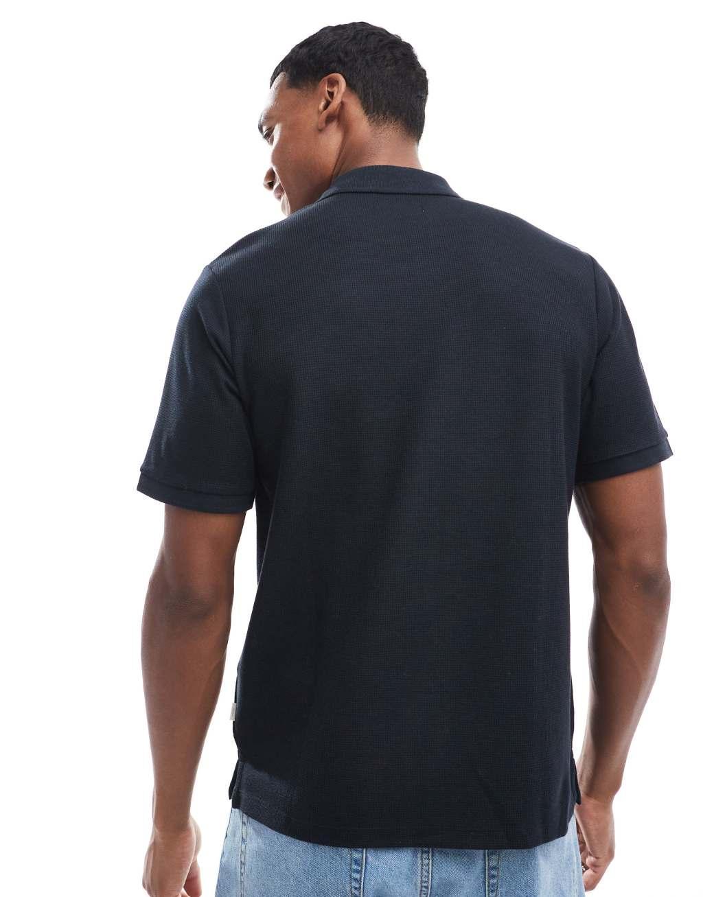 Jack & Jones waffle zip up polo in black Product Image