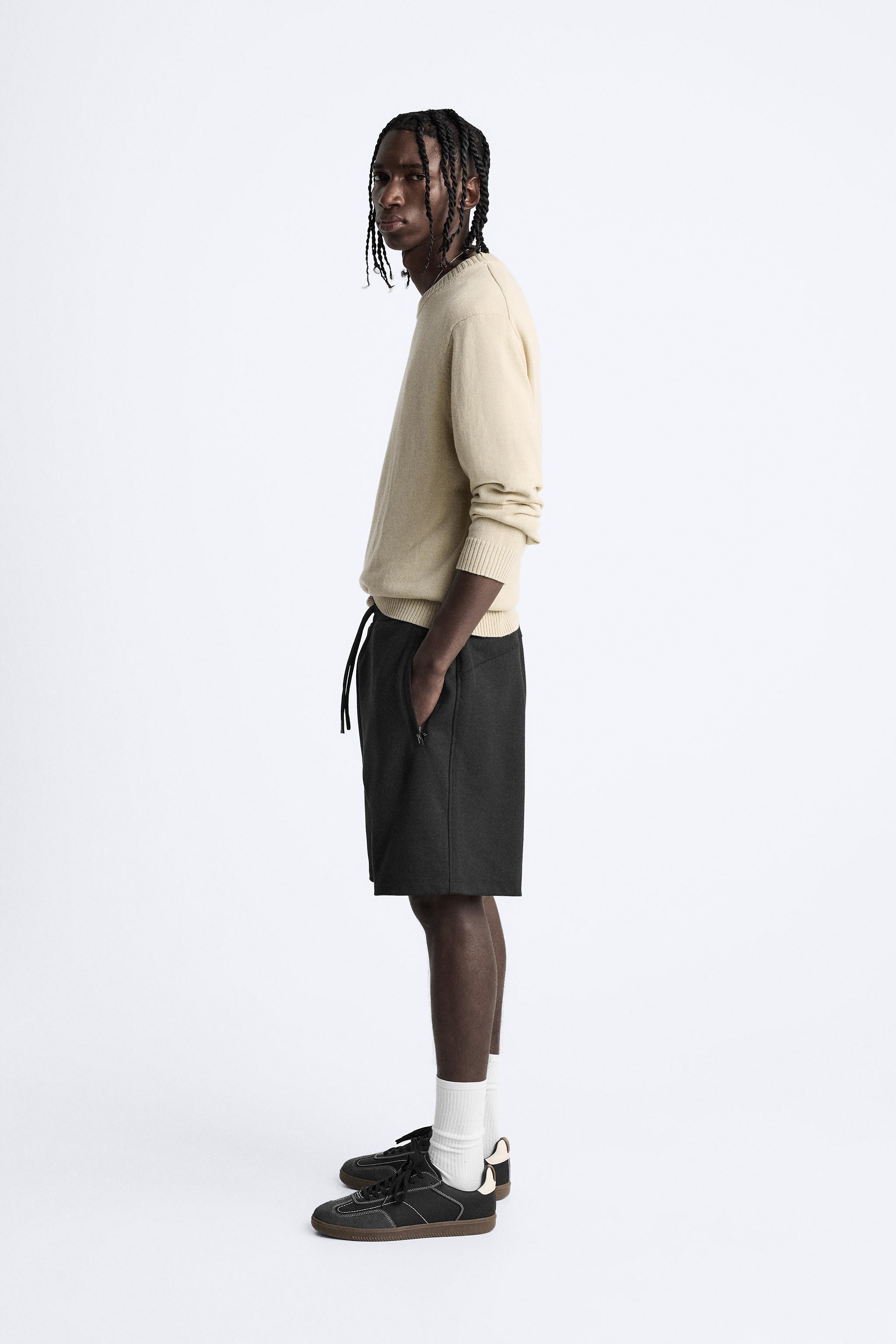 Relaxed fit shorts. Adjustable elastic waistband with drawstring. Front zip pockets. Product Image