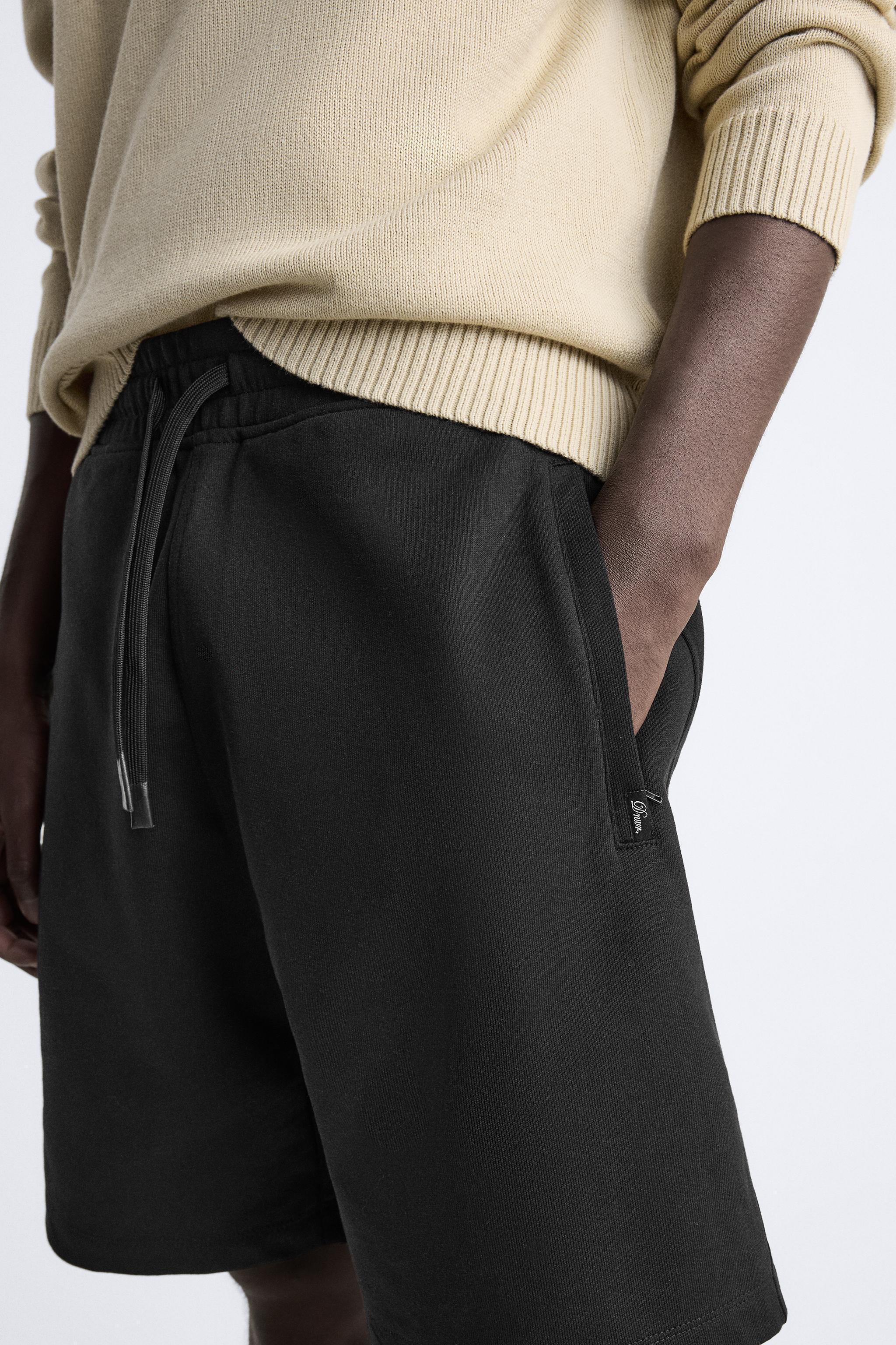 Relaxed fit shorts. Adjustable elastic waistband with drawstring. Front zip pockets. Product Image