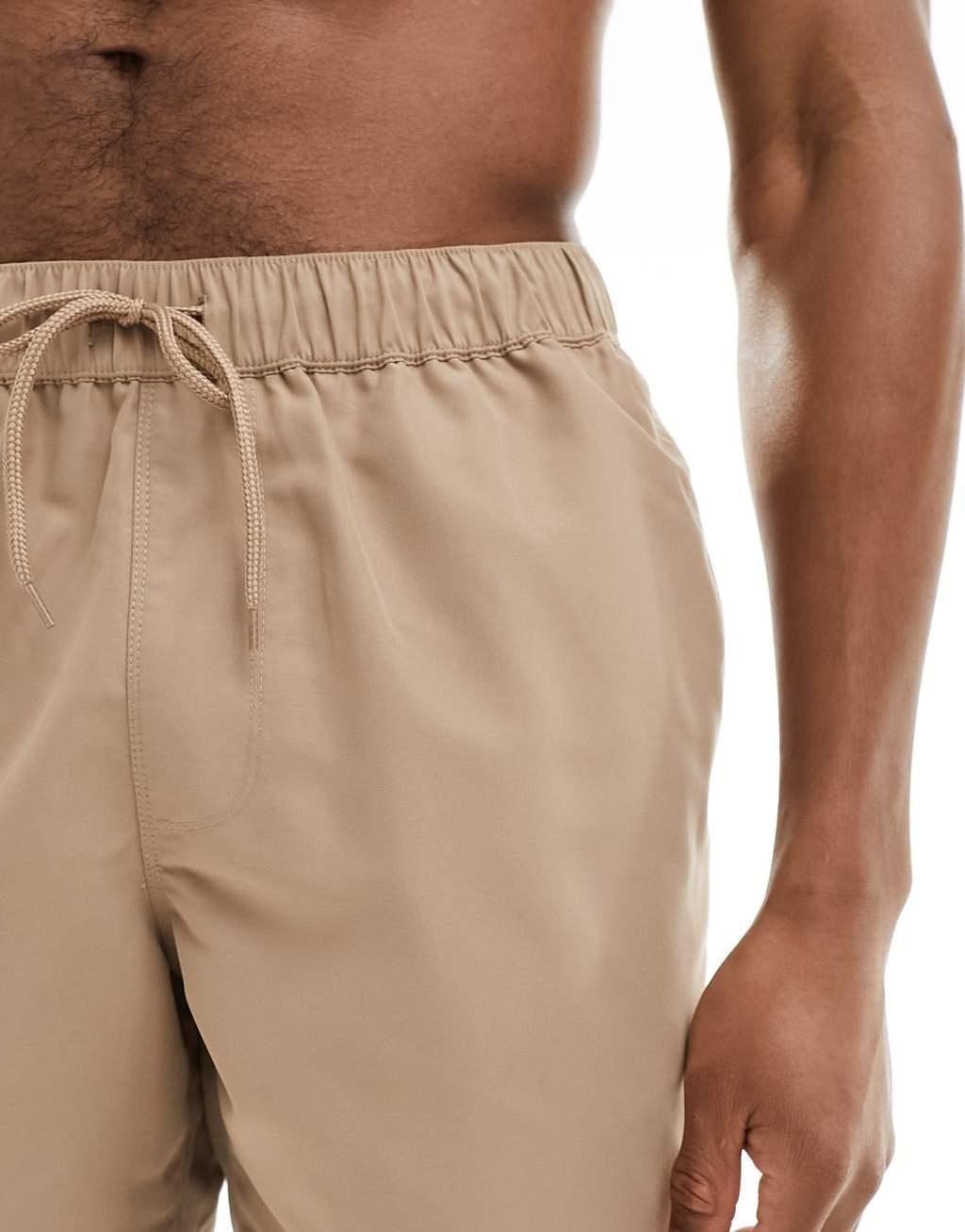 ASOS DESIGN swim shorts in mid length in brown Product Image