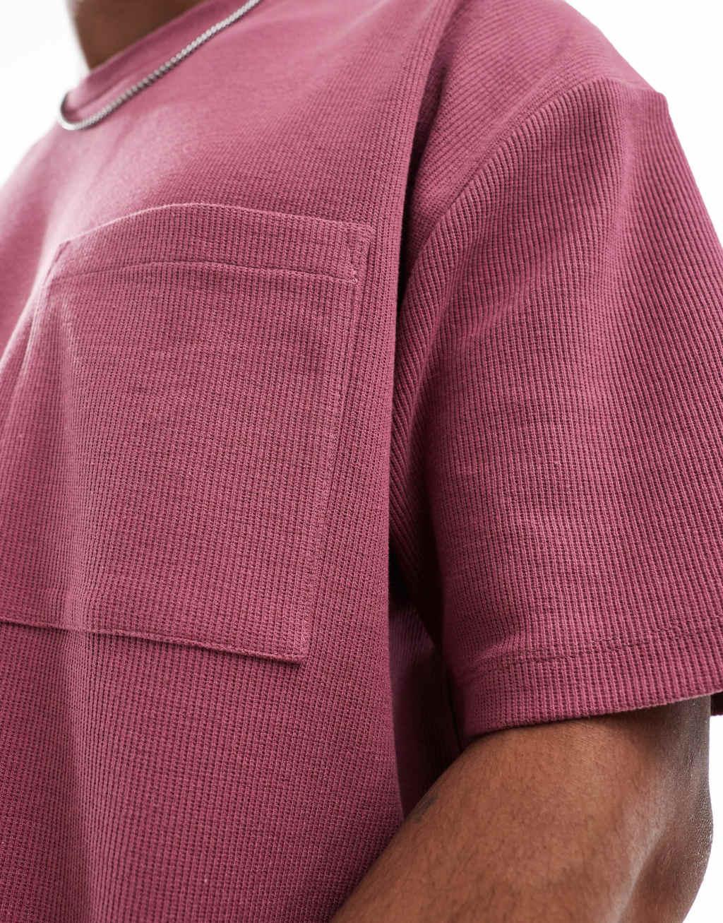 ASOS DESIGN oversized textured t-shirt with front pocket in pink Product Image