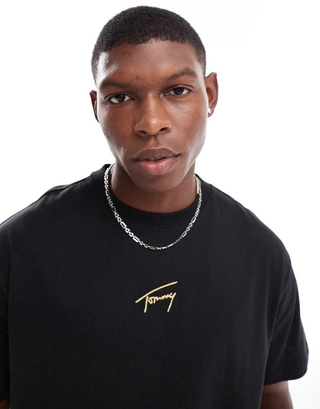 Tommy Jeans gold central logo t-shirt in black Product Image