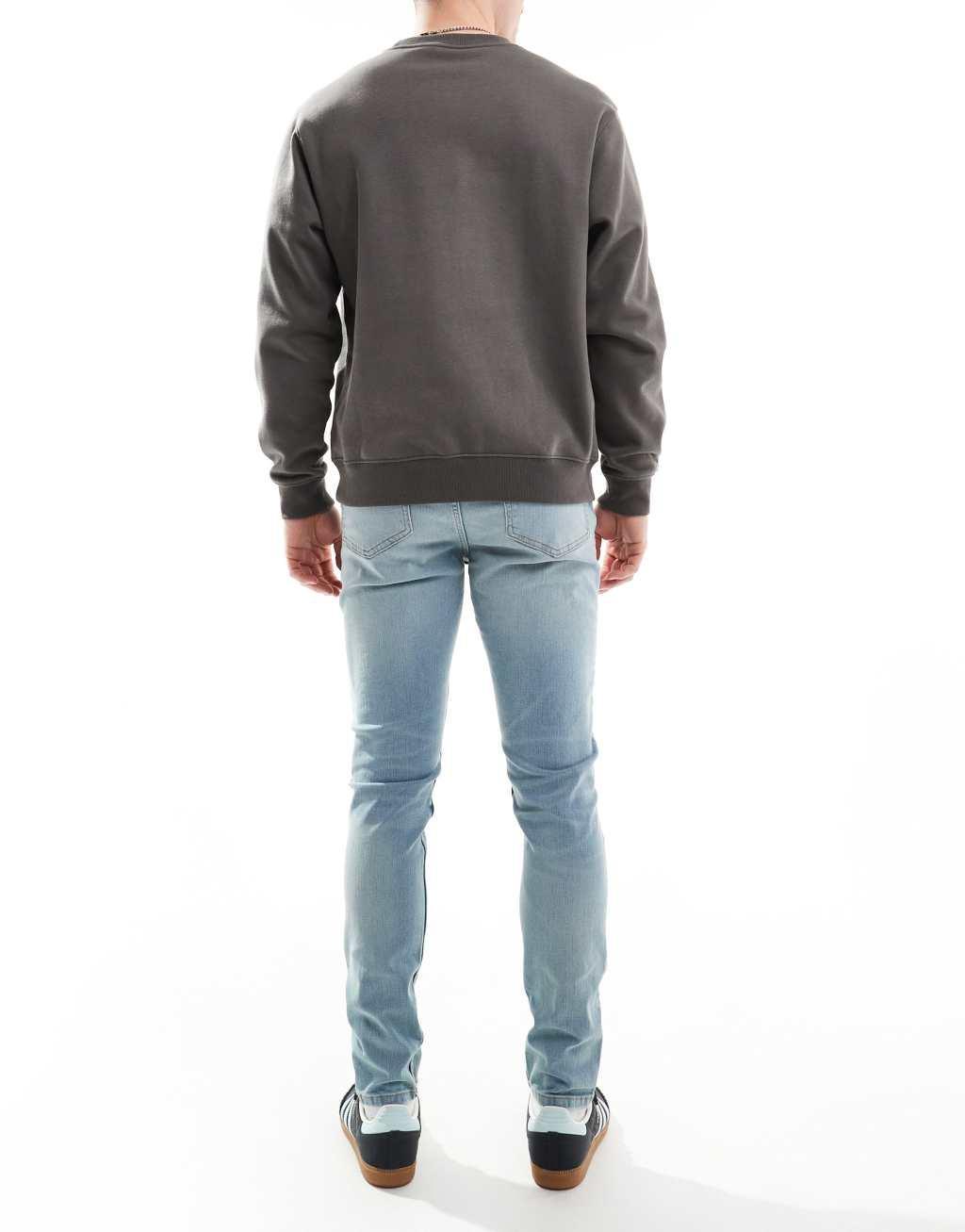 ASOS DESIGN skinny jeans in light wash blue with tint Product Image