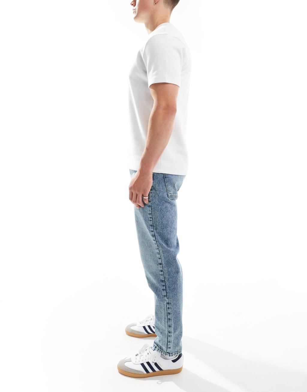 ASOS DESIGN tapered fit jeans in mid wash blue  Product Image