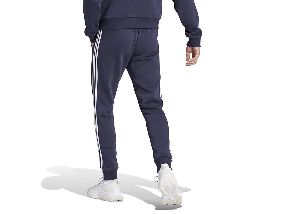 adidas Essentials Fleece Tapered Cuffed 3-Stripes Pants (Ink) Men's Clothing Product Image