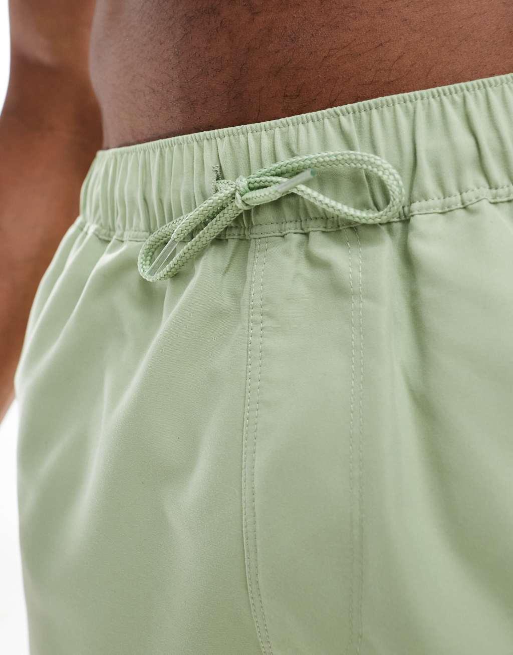 ASOS DESIGN swim shorts in short length in green Product Image