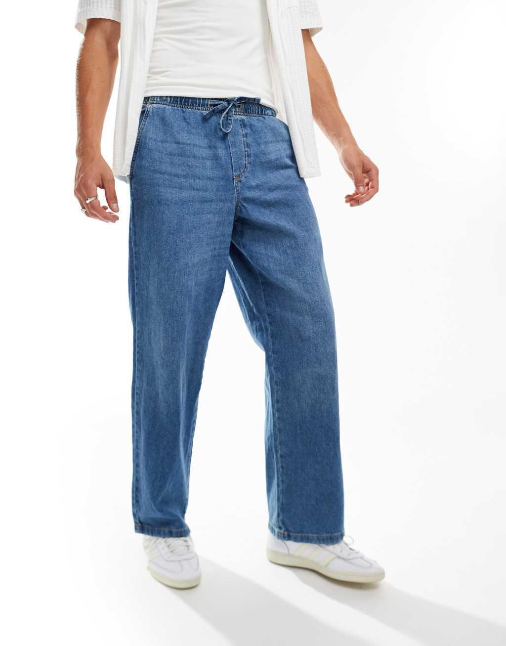 Jack & Jones eddie baggy drawstring jeans in mid blue wash Product Image