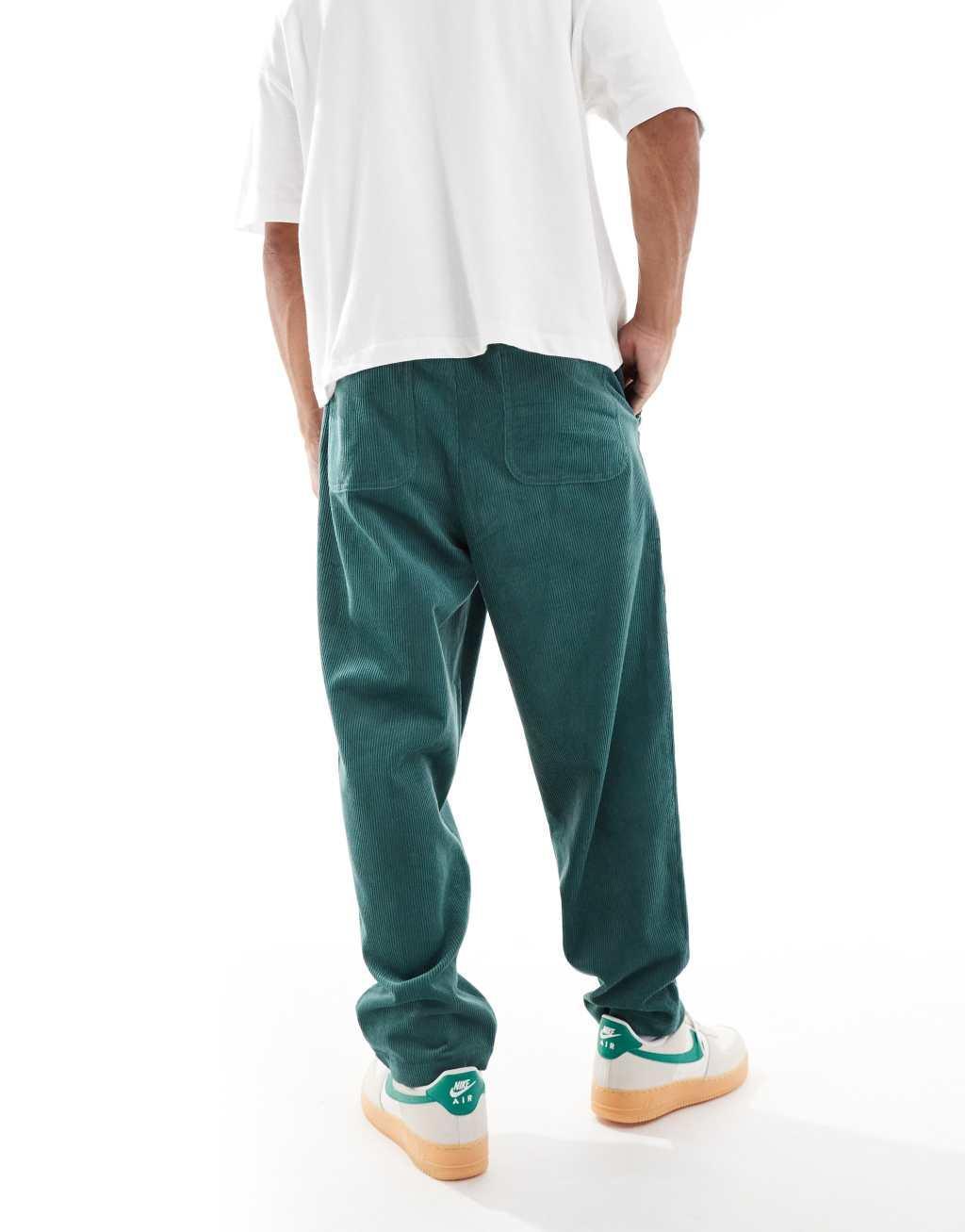 ASOS DESIGN tapered cord pants in green Product Image