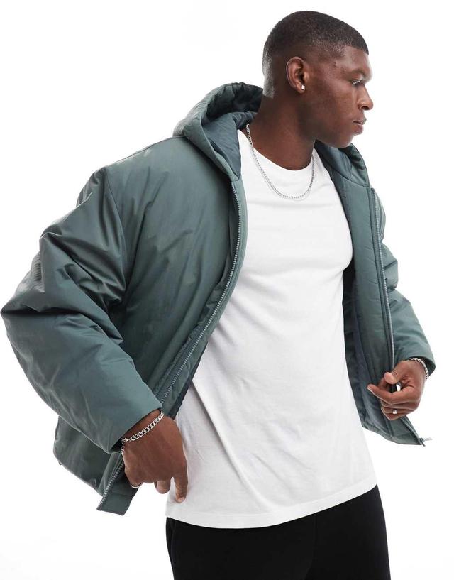 ASOS DESIGN oversized puffer jacket with hood in green Product Image