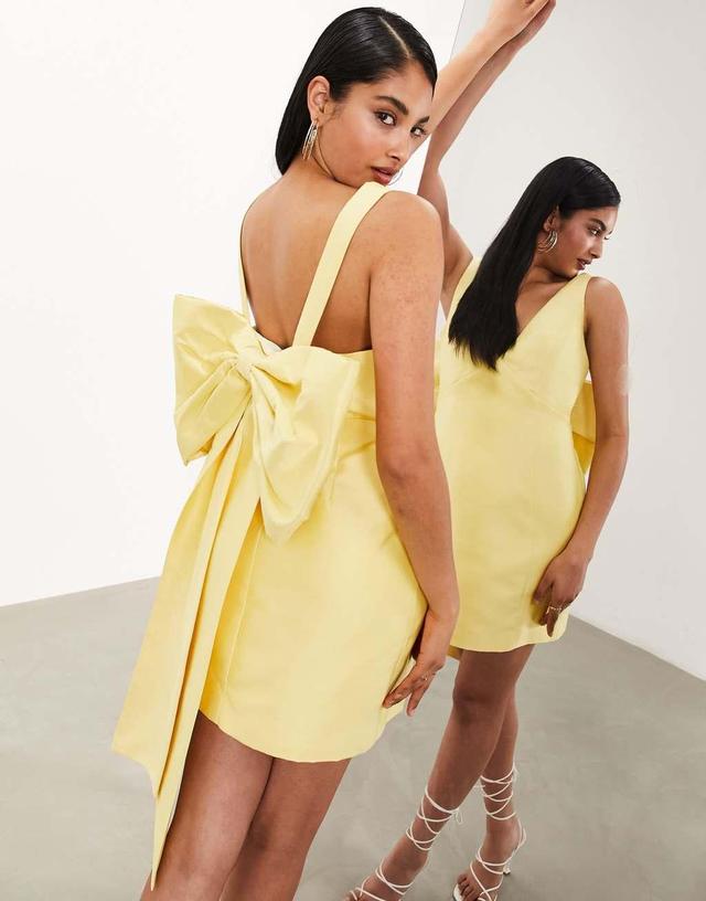 ASOS EDITION structured mini dress with statement bow back detail in yellow Product Image