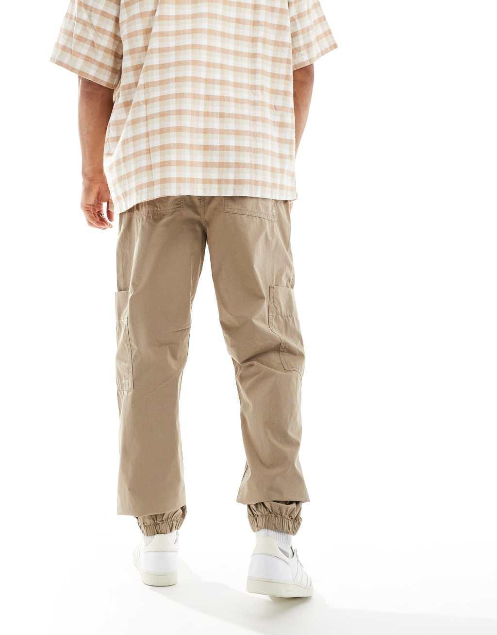 ASOS DESIGN tapered pull on cargo sweatpants in brown  Product Image