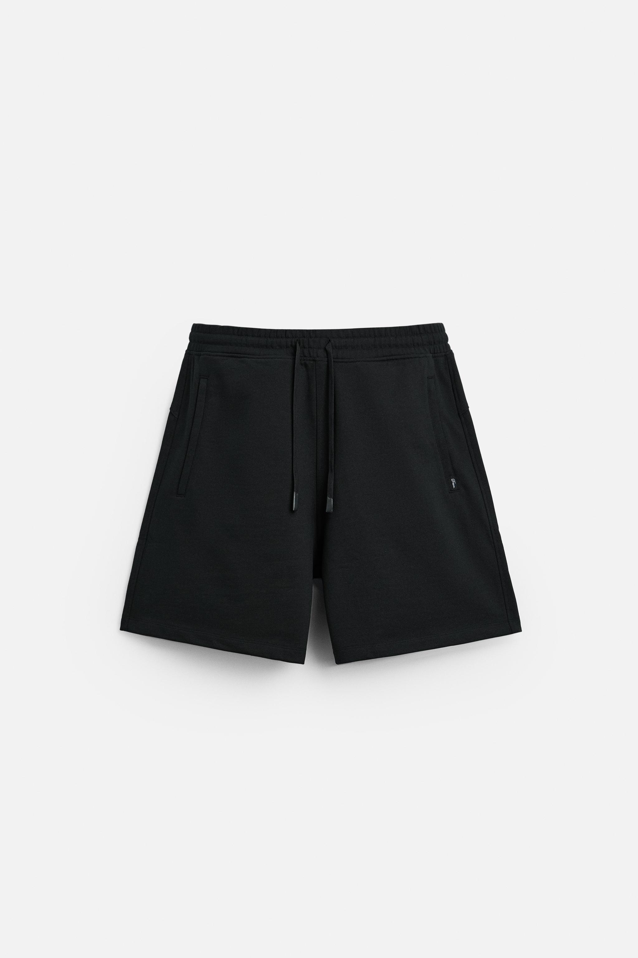 Relaxed fit shorts. Adjustable elastic waistband with drawstring. Front zip pockets. Product Image