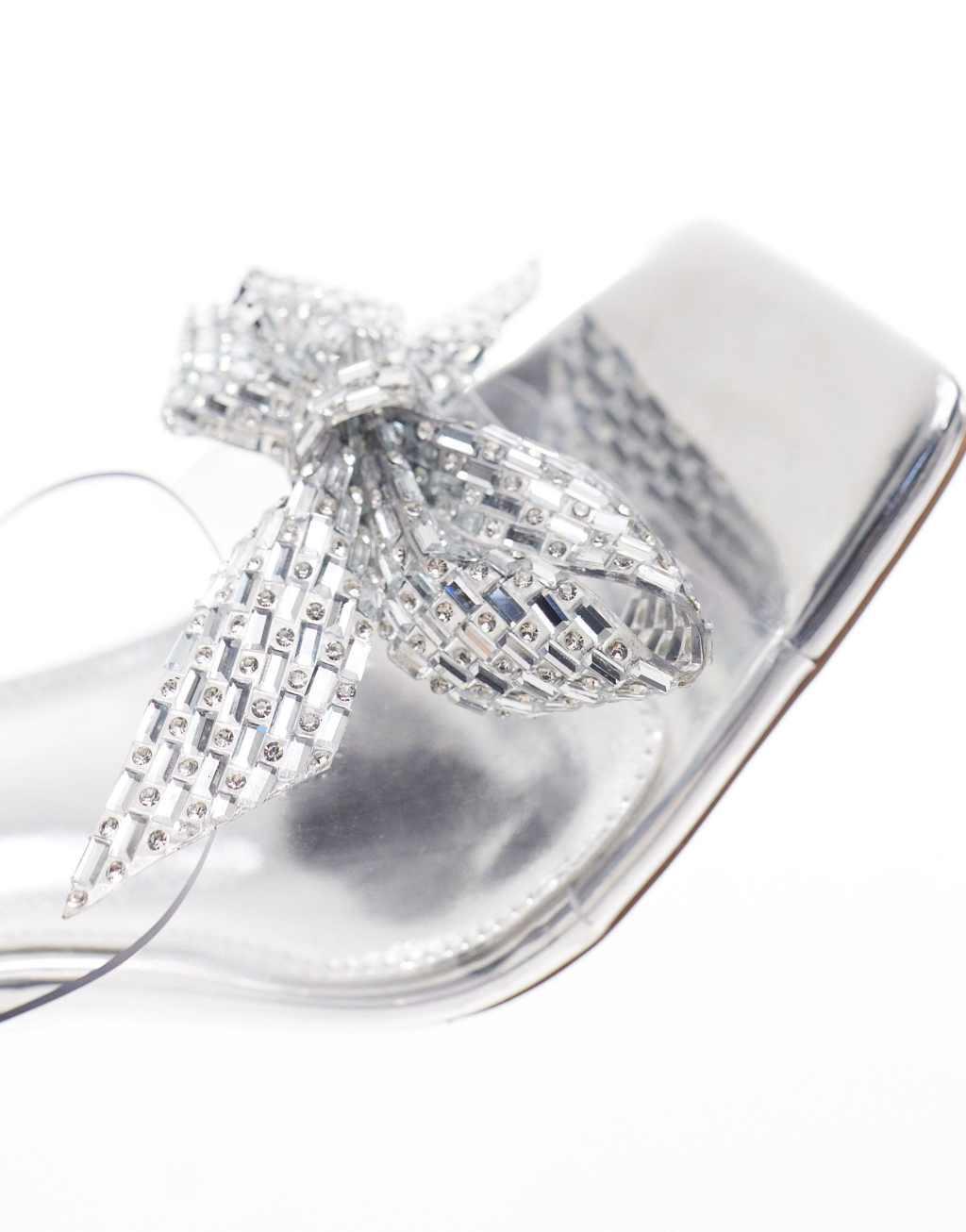 Simmi London Wide Fit Ashleigh clear mid heeled mules with embellished bow in silver Product Image