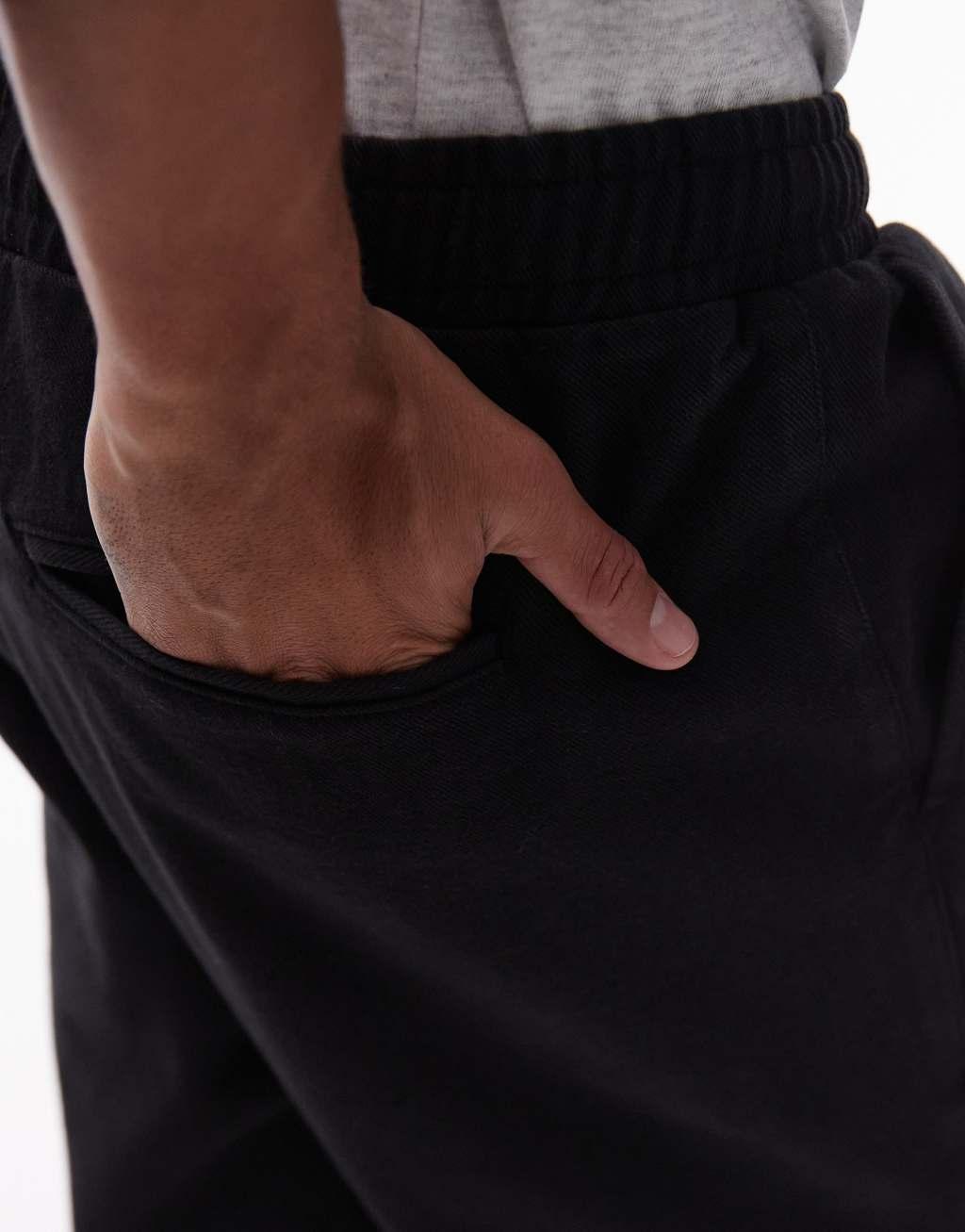 Topman tapered pants with elasticated waistband in black Product Image