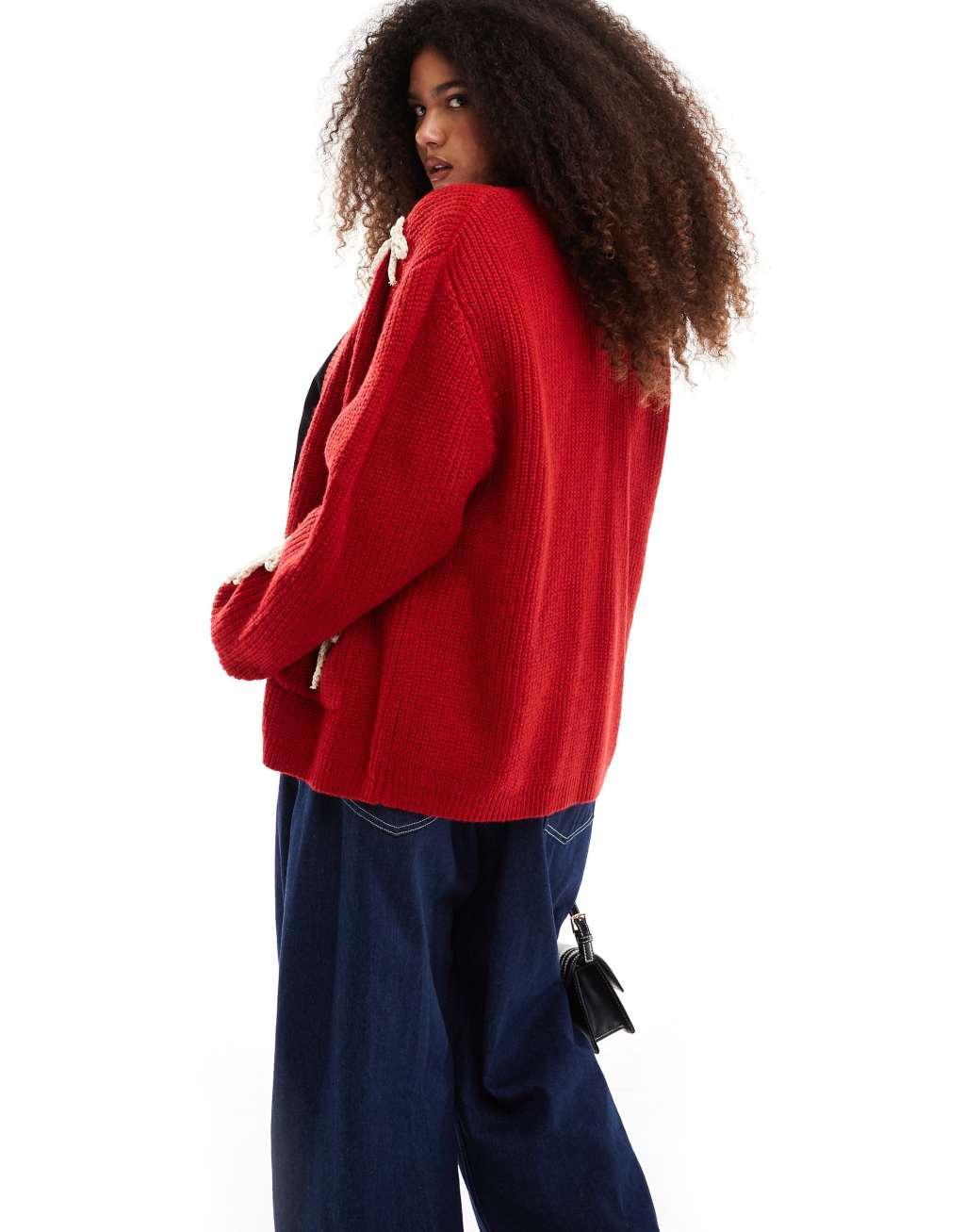 Renee Studio x Michelle Nayla exclusive fluffy bow pocket detail knitted cardigan in red Product Image