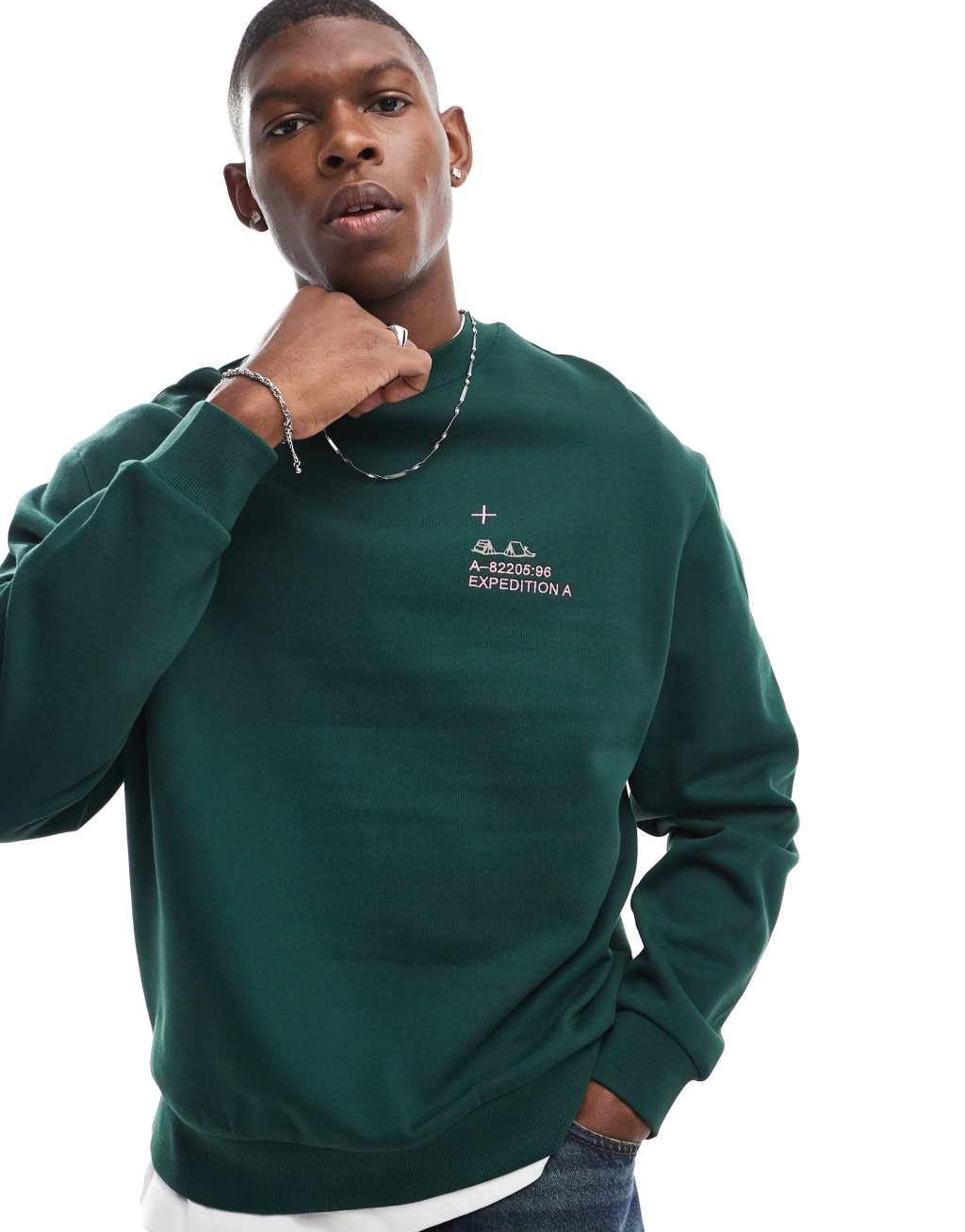 ASOS DESIGN oversized sweatshirt with chest embroidery and mountain back print in dark green Product Image