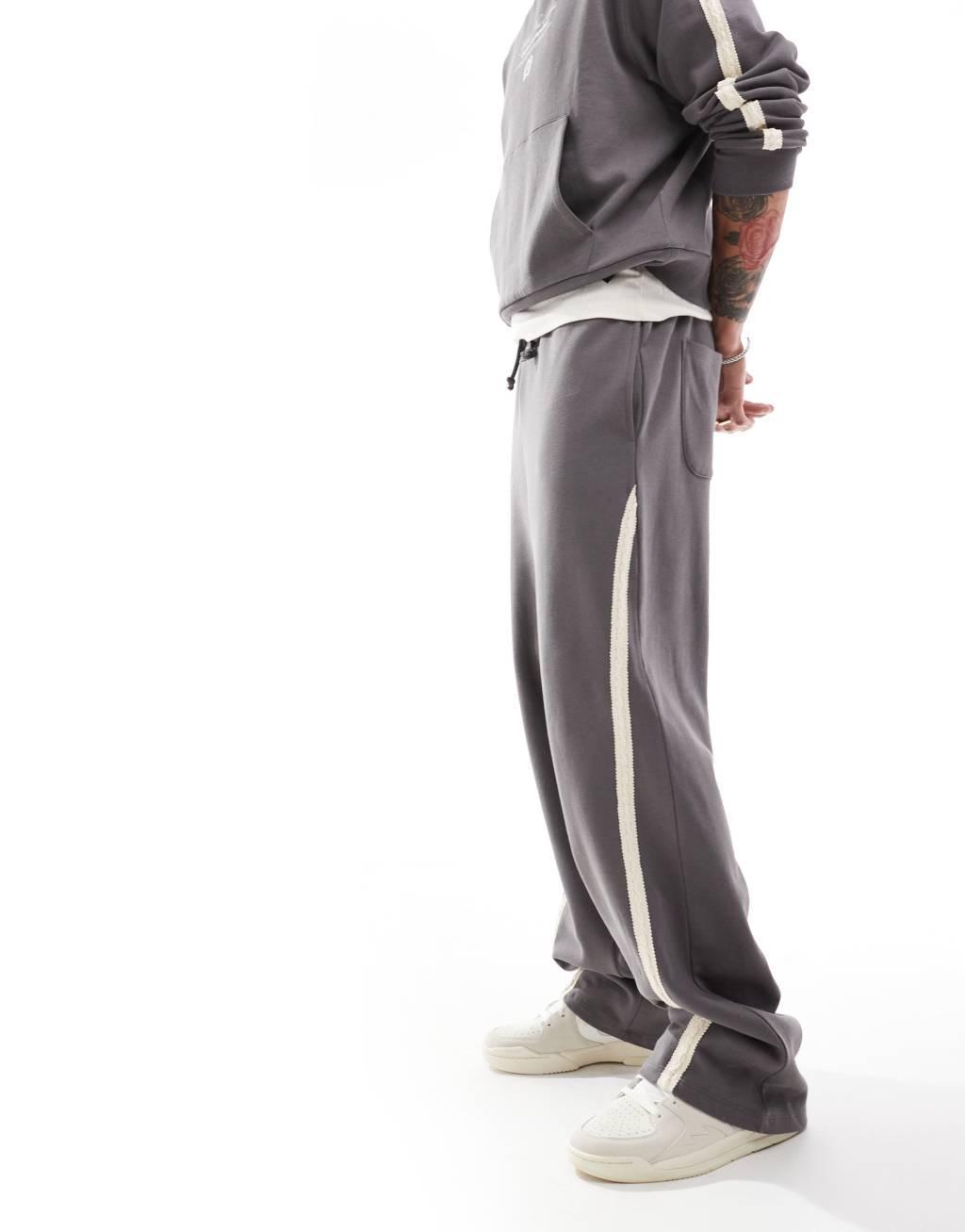 ASOS DESIGN extreme wide leg sweatpants with slanted side tape with text print in charcoal Product Image