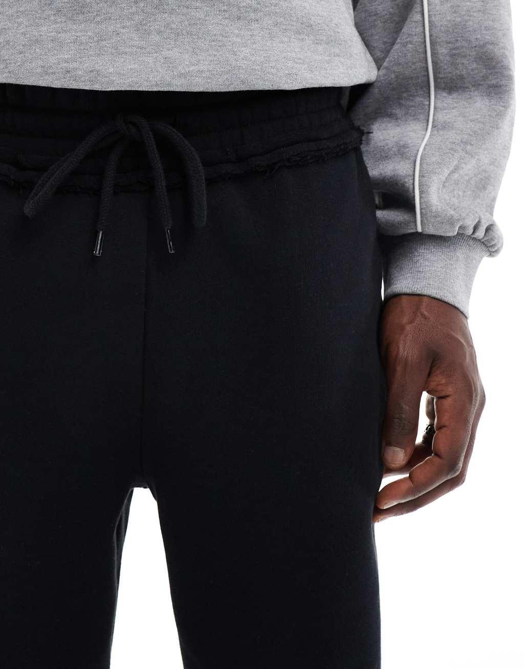 ASOS DESIGN straight leg sweatpants with raw edge detail in black Product Image