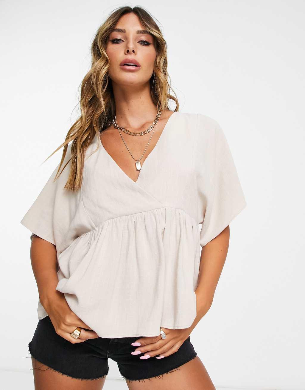 ASOS DESIGN wrap top with angel sleeve & peplum hem in natural Product Image