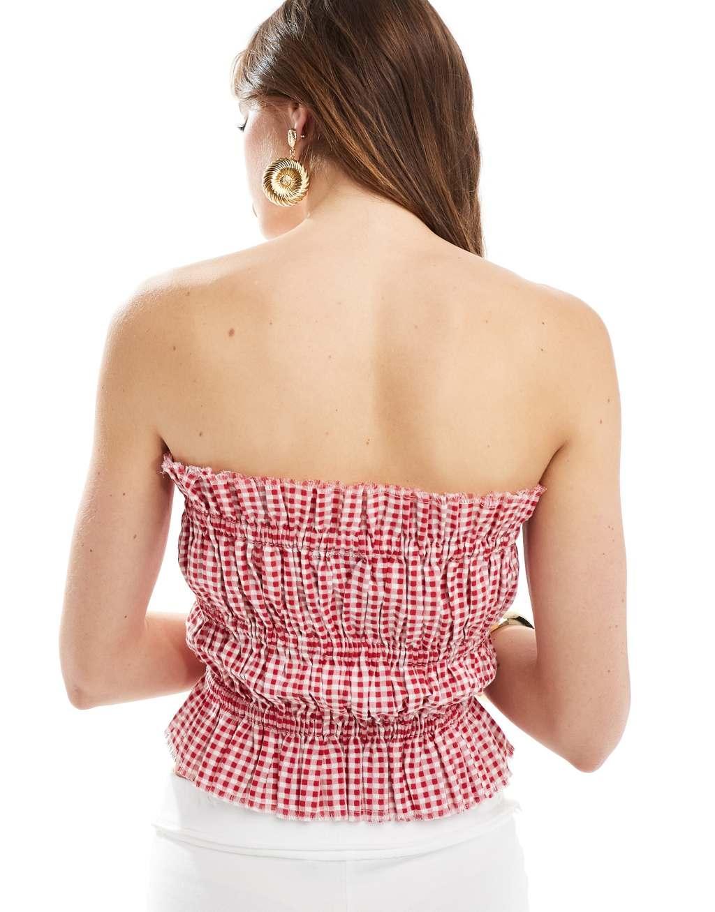 ASOS DESIGN shirred bandeau with raw edge in red gingham Product Image