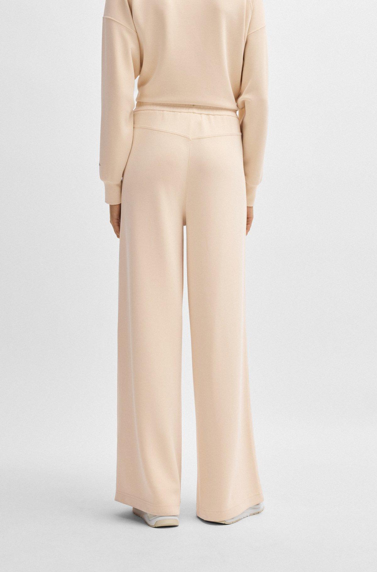 Wide-leg tracksuit bottoms with pleat details Product Image