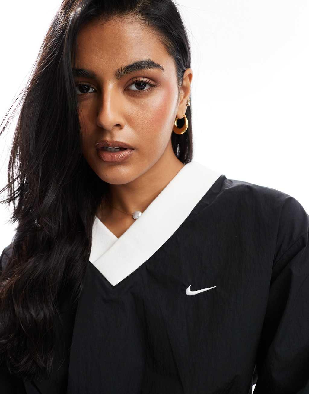 Nike Windrunner woven long sleeve crew neck top in black Product Image