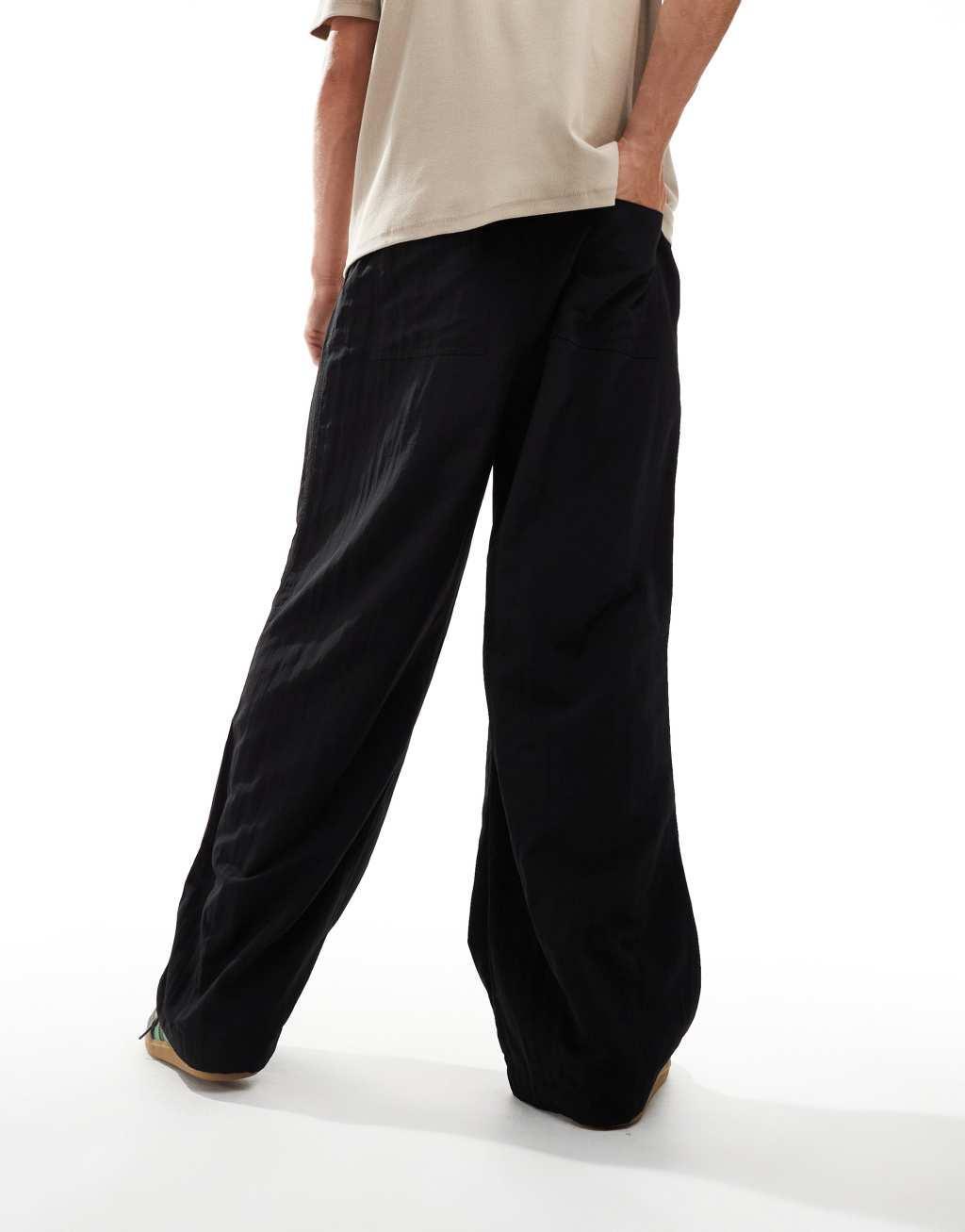 ASOS DESIGN baggy balloon chinos with pleats in black Product Image