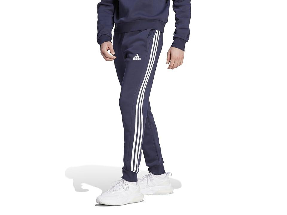 adidas Essentials Fleece Tapered Cuffed 3-Stripes Pants (Ink) Men's Clothing Product Image