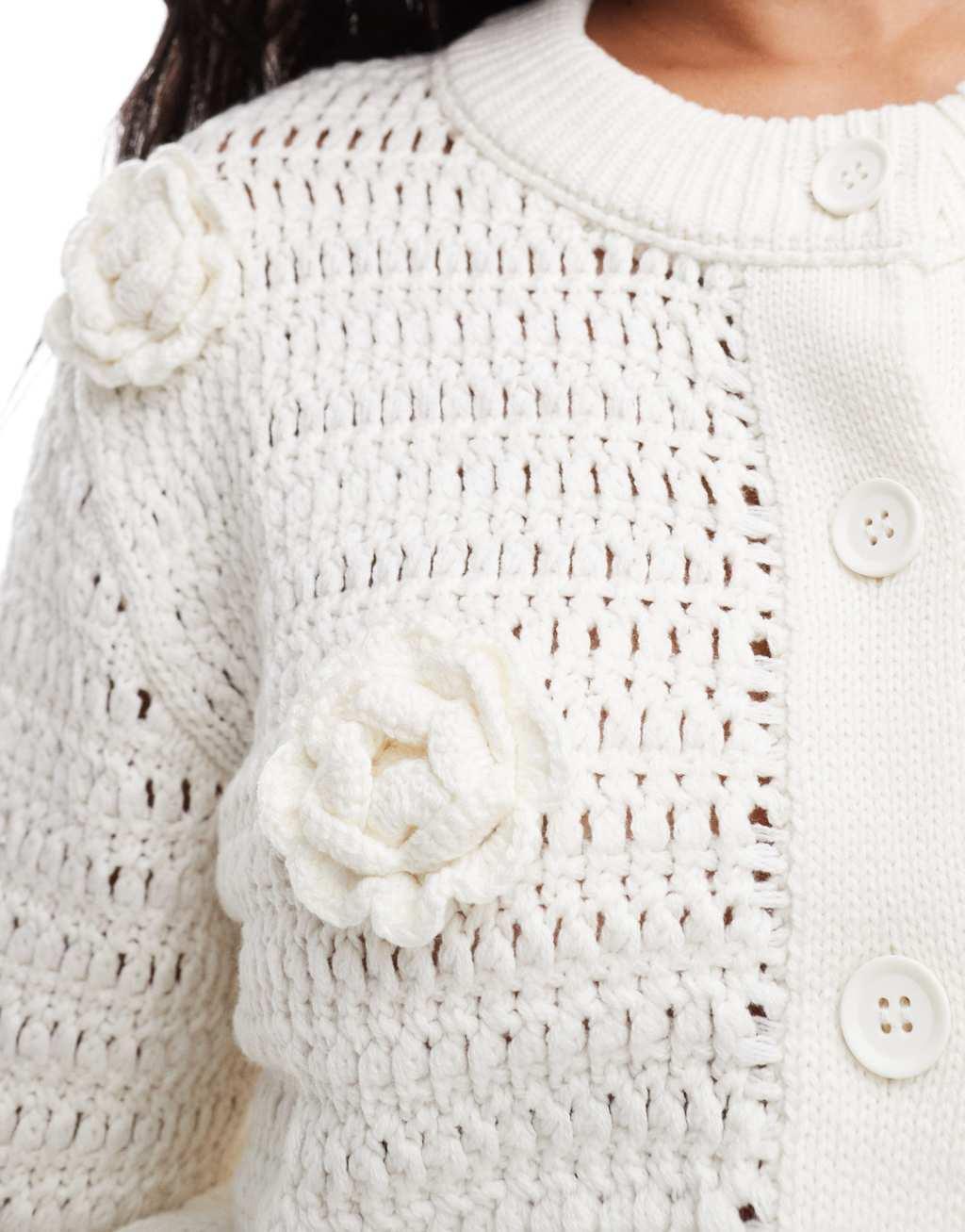 ASOS DESIGN knit crew neck cardigan in open stitch with crochet flower detail in cream Product Image