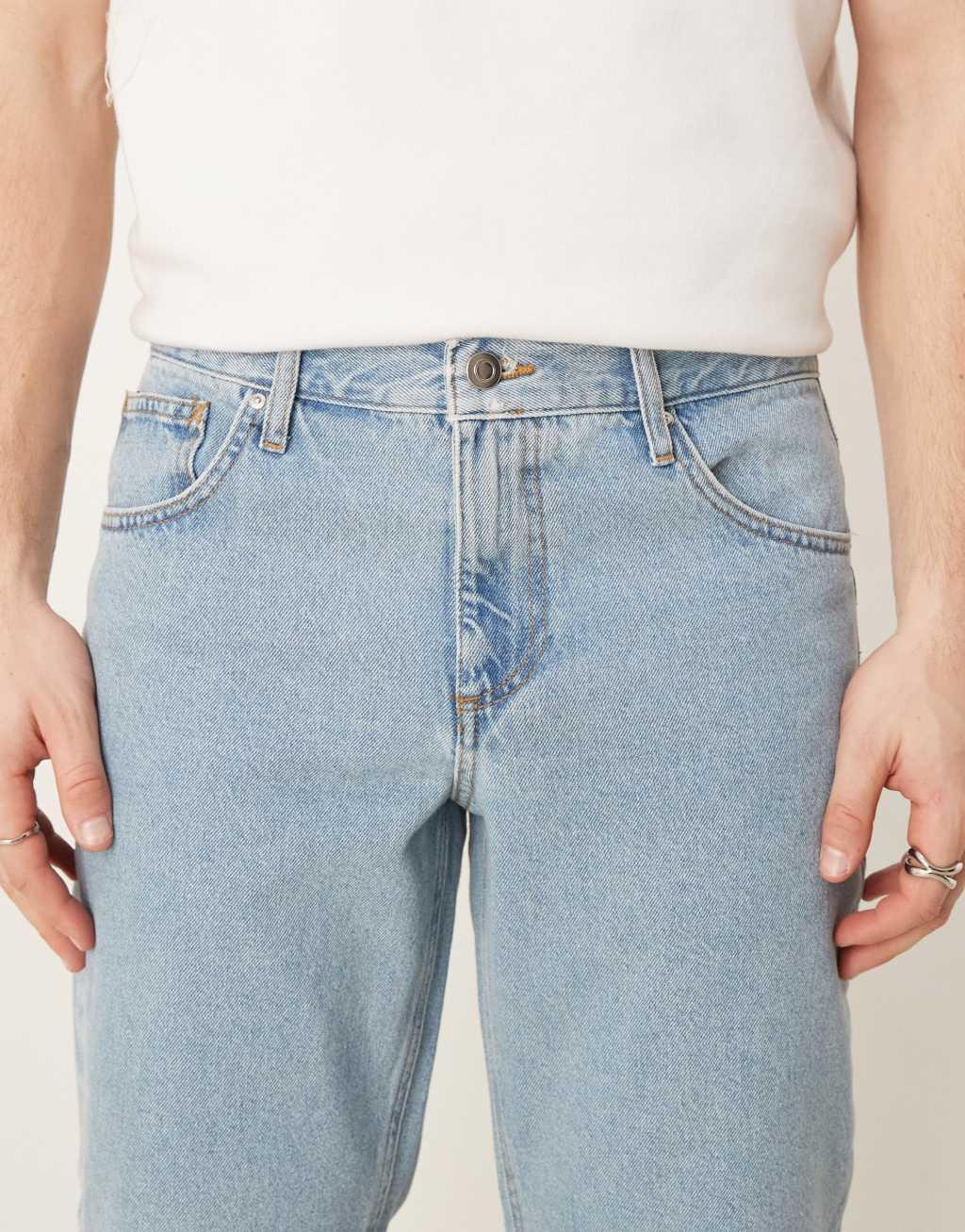 ASOS DESIGN tapered fit jeans in mid wash blue   Product Image