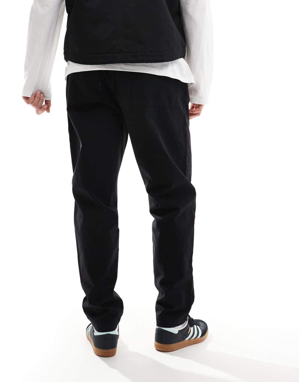 ASOS DESIGN tapered pull on pants with back pocket patch in black Product Image