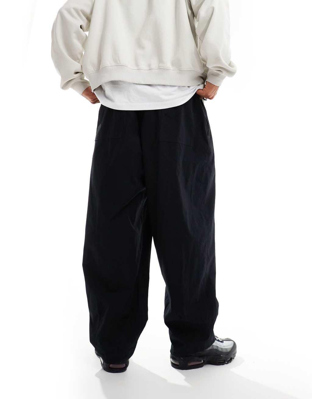 Nike Club woven balloon pants in black Product Image