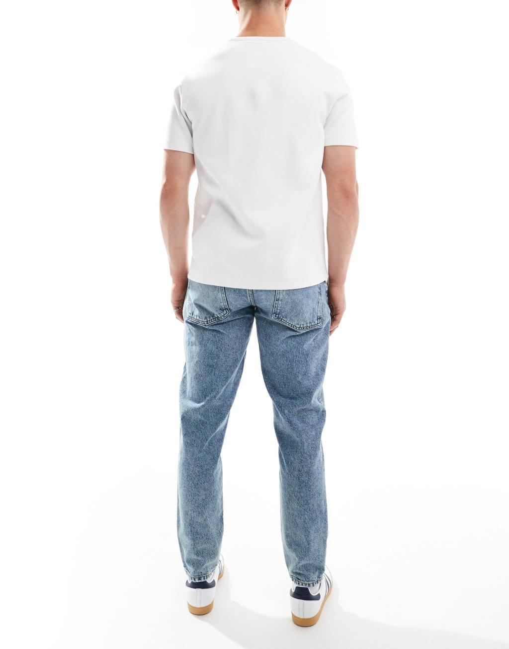 ASOS DESIGN tapered fit jeans in mid wash blue  Product Image