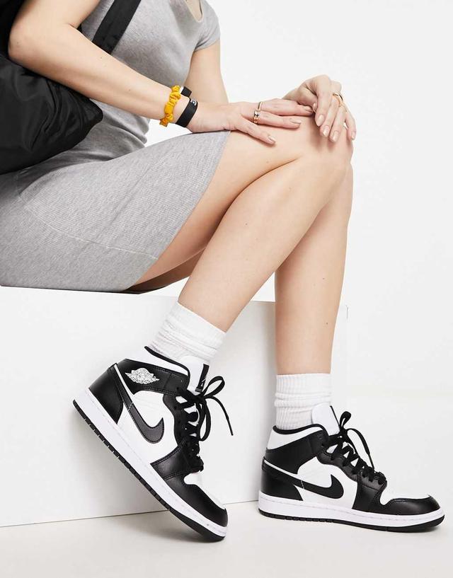 Nike Air Jordan 1 Mid sneakers in white and black  Product Image