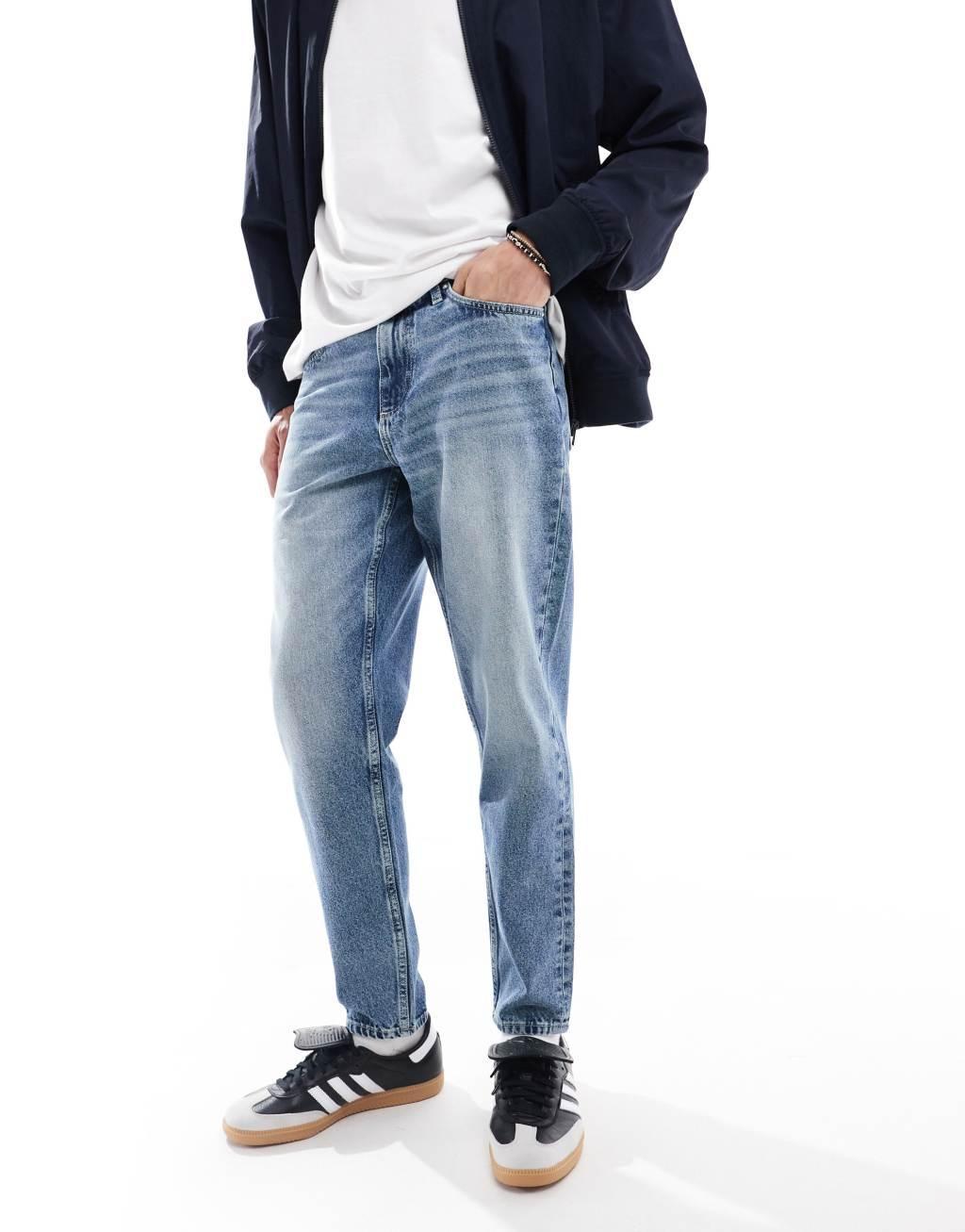 ASOS DESIGN tapered fit jeans in mid wash blue  Product Image