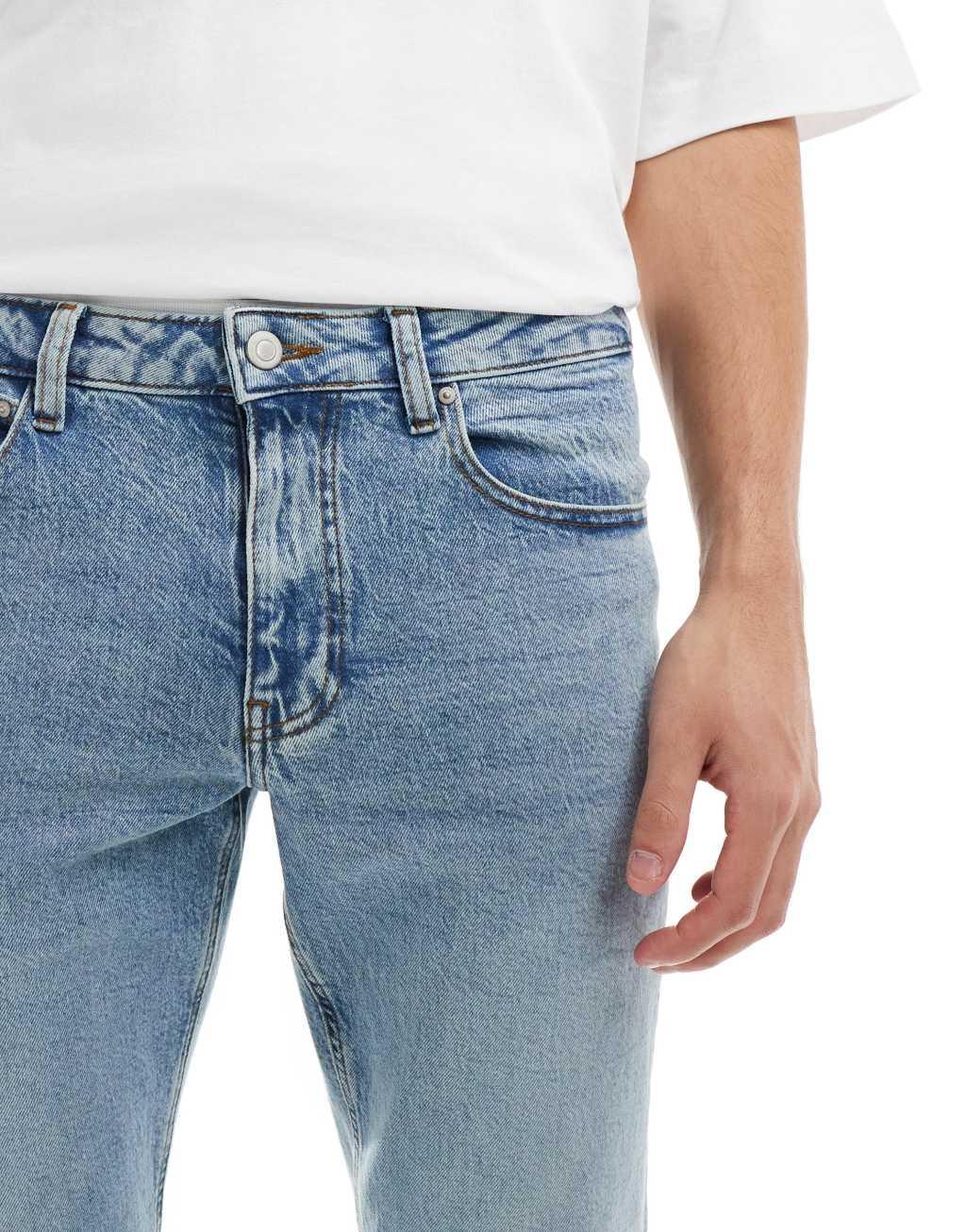 ASOS DESIGN stretch tapered jeans in light wash blue Product Image