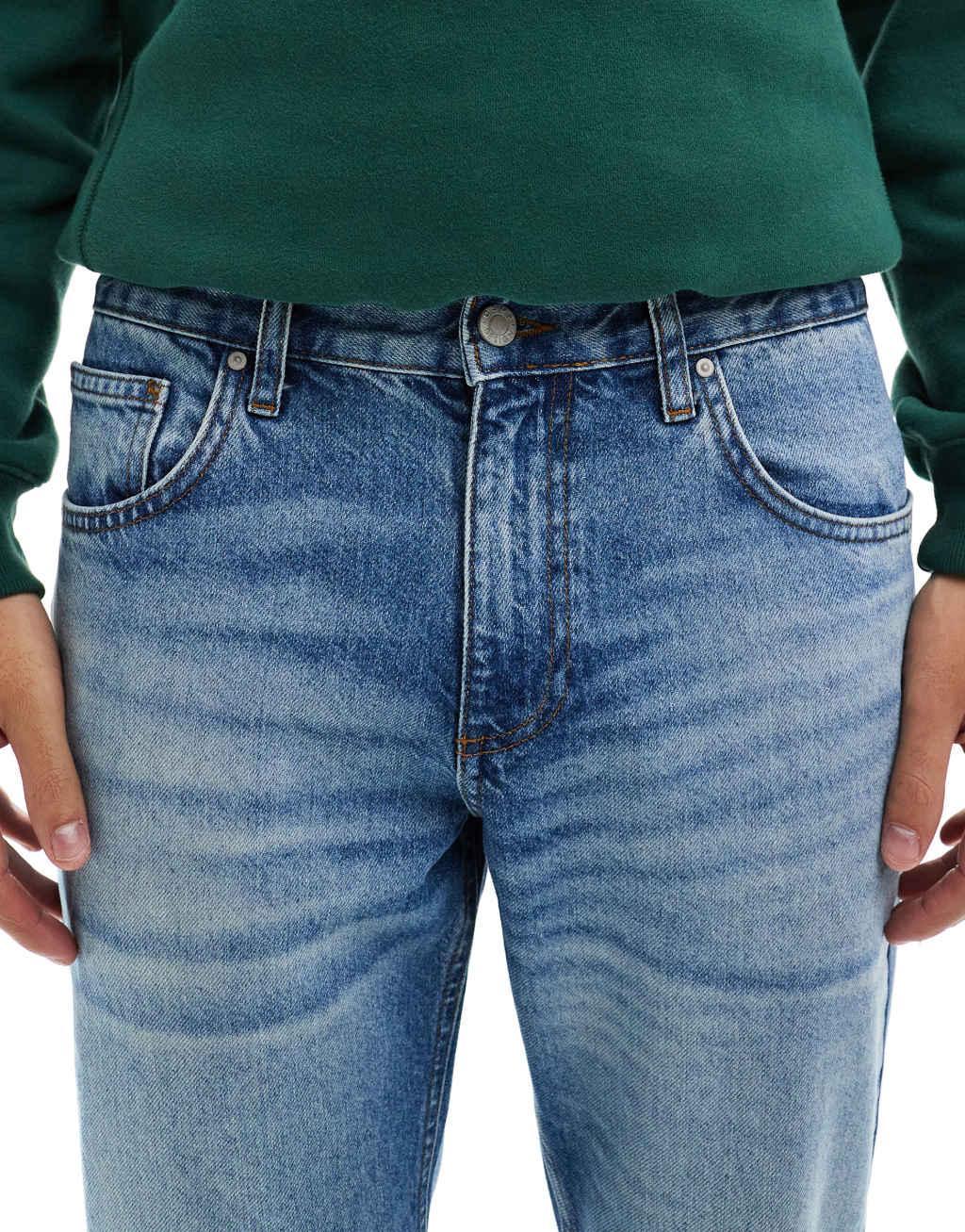 ASOS DESIGN tapered jeans in mid wash blue Product Image