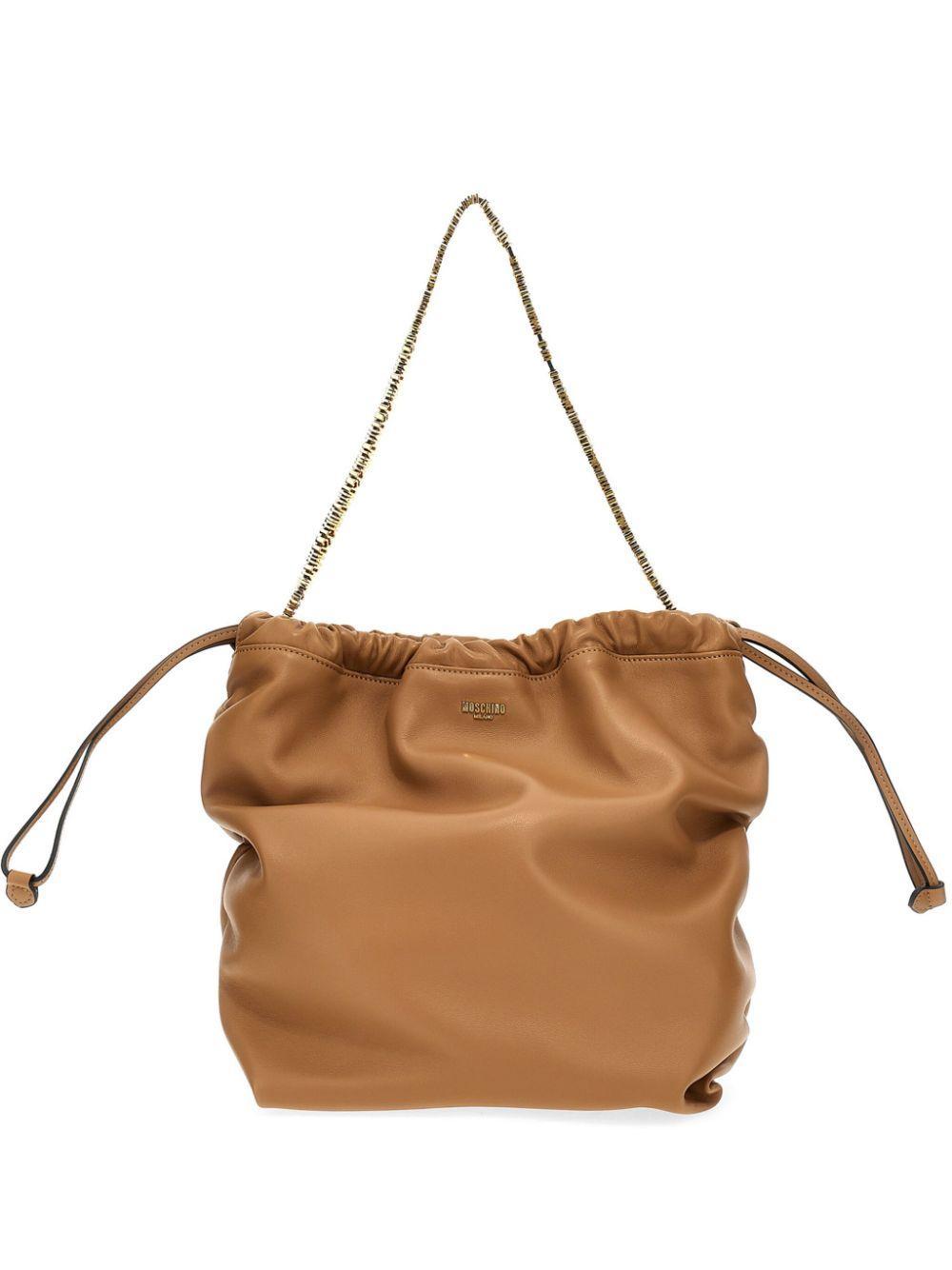 MOSCHINO Logo Plaque Drawstring Shoulder Bag In Brown Product Image