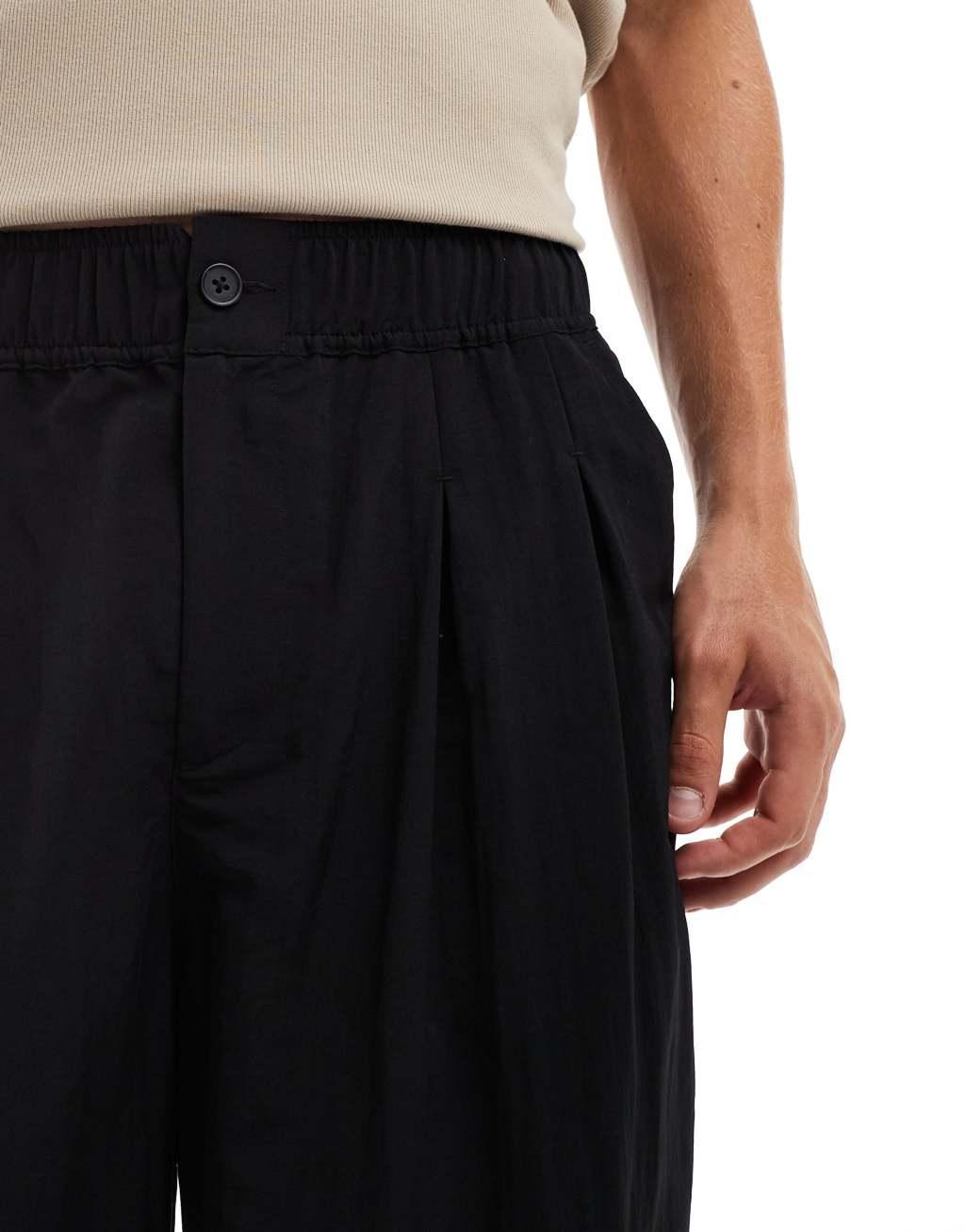 ASOS DESIGN baggy balloon chinos with pleats in black Product Image