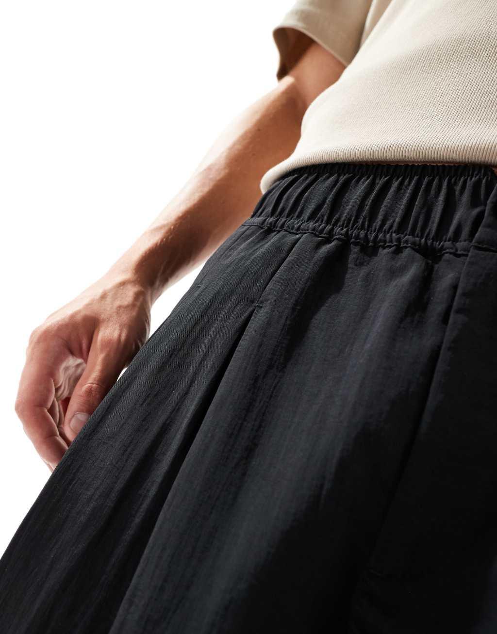 ASOS DESIGN baggy balloon chinos with pleats in black Product Image