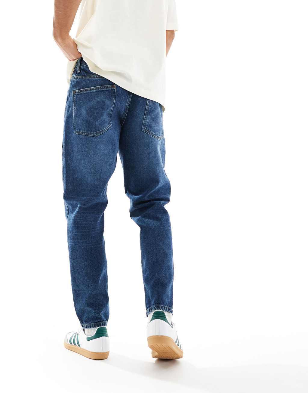 ASOS DESIGN tapered fit jeans in dark wash blue Product Image