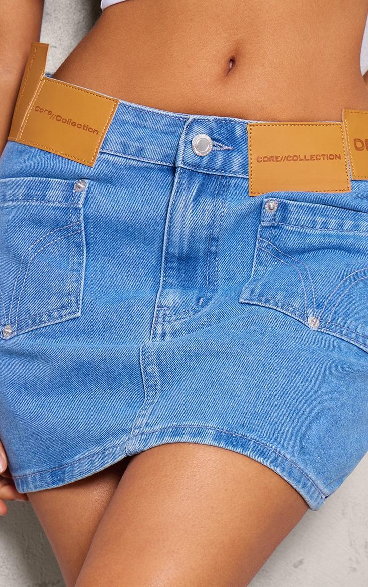 Petite Mid Blue Wash Denim Low Rise Badge Detail Mini Skirt Product Image