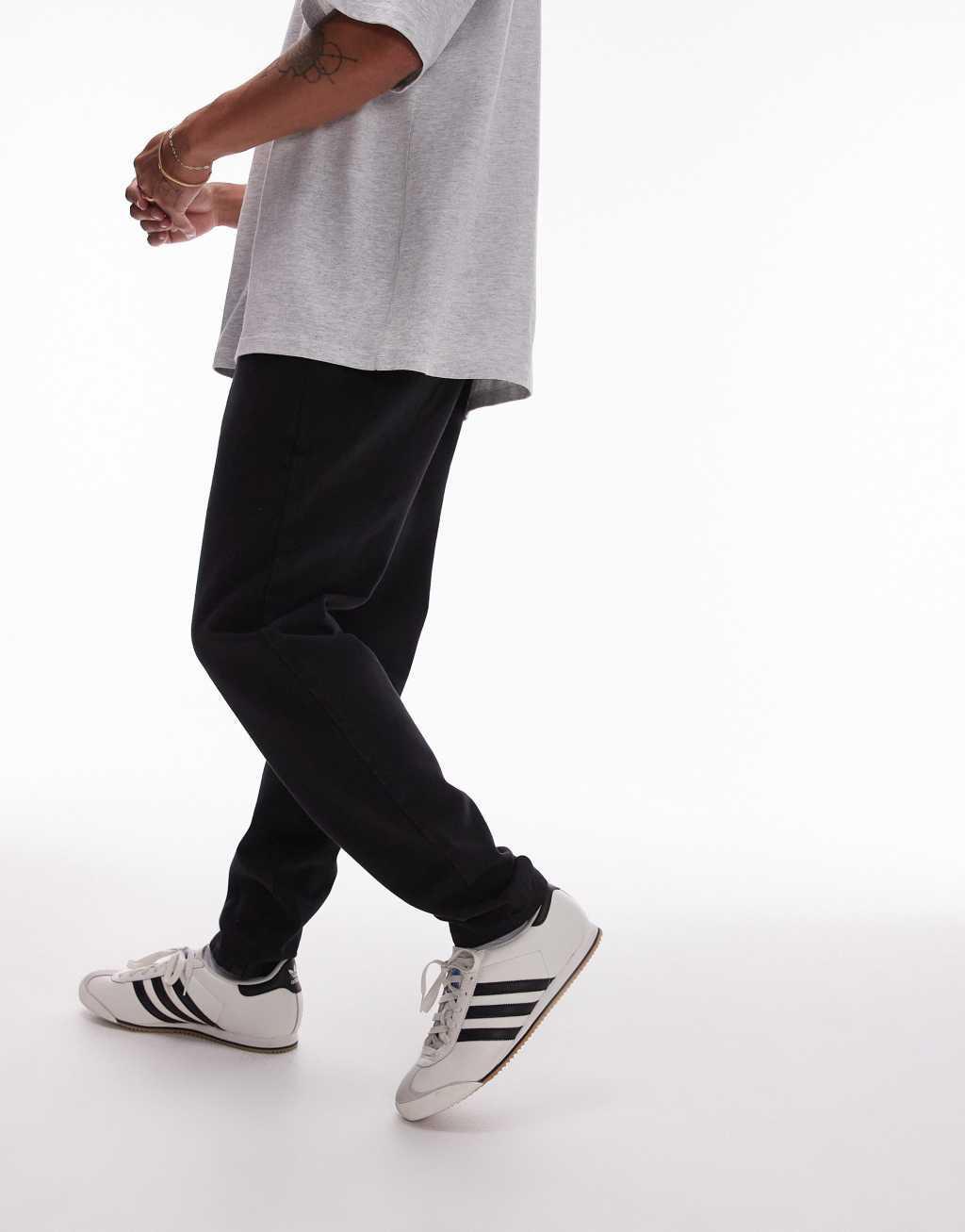 Topman tapered pants with elasticated waistband in black Product Image